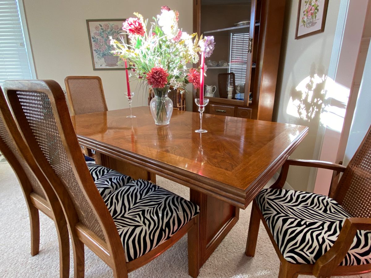 Fabulous Pecan dining table and six chairs, purchased over 40 years ago for $4000 with six Cane back, re-upholstered seats in a fun Zebra Print! Probably Thomasville