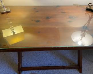 Large wooden table with a glass top, used as a desk, also would make a great dining table