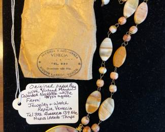 Original paper bag with vintage Mayan Calendar necklace of white onyx and agate