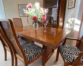 Fabulous Pecan dining table and six chairs, purchased over 40 years ago for $4000 with six Cane back, re-upholstered seats in a fun Zebra Print! Probably Thomasville
