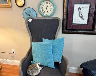 Grey side chair, clocks, framed art