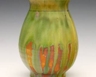 An early 20th century Pewabic Art Pottery vase.  Baluster form with flared rim and drip glaze in mottled shades of Green, Yellow and Iridescent Copper Red.  Faintly impressed "Pewabic Detroit" mark.  Minor wear, crazing.  6" high.