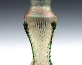A turn of the century Kralik "Rigaree" Art Glass vase.  Baluster form Iridescent "Martele" glass vase with applied Green "Rigaree" swirls.  Chip to swirl and base near foot, minor surface wear.  14 1/2" high.   NOTE: From the estate of Bill & Barbara Shulhof of Saginaw, Michigan.