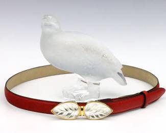 Two pieces of late 20th century Lalique frosted Crystal.  Includes a "Perdix" Partridge figure and a "Tropiques Veau" buckle with Red "snakeskin" leather belt.  Partridge signed "Lalique France", buckle impressed "Lalique" and belt marked "Paris / Lalique / Made in France".  Leather belt with very minor creasing.  Partridge is 5 1/2" high, belt is 36" long overall including buckle.  