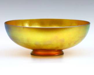 An early 20th century Steuben Art Glass center bowl.  Low footed form Gold Aurene finish.  Signed "Aurene" and "2852".  Minor surface wear.  9" diameter x 3 1/4" high overall.   NOTE: From the estate of Bill & Barbara Shulhof of Saginaw, Michigan.