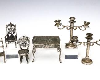 Six 19th to 20th century Silver miniature figures.  Includes a pair of Mexican Sterling candelabra, a Continental .800 Silver table with Romantic scenic decoration, two Dutch .835 Silver chairs, and a Sterling filigree chair.  Candelabra marked "925 / Hecho en Mexico", Table marked "800", chairs with Dutch Sword hallmarks, filigree chair unmarked but tested Sterling.  3.98 troy ozs total.  Some surface wear.  Up to 2" high.   NOTE: From the estate of Bill & Barbara Shulhof of Saginaw, Michigan.