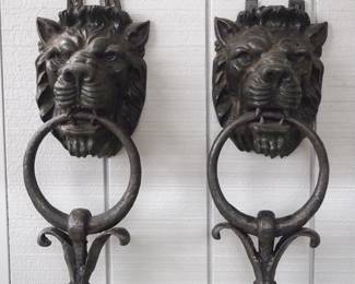 A massive pair late 19th century cast iron door knockers.  Lion's mask design with lower ring shaped drops.  Re-painted Black finish, minor damage.  Each 9 x 22" high.  