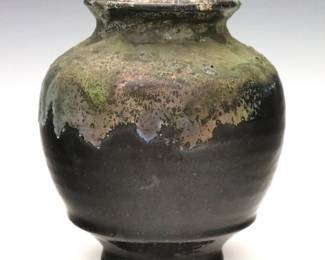 An early 20th century Pewabic Art Pottery vase.  Bulbous form with flared rim and drip glaze in mottled shades of Black, Pale Green and Silver.  Impressed "Pewabic Detroit" mark.  Minor wear, some crazing.  5" high. 