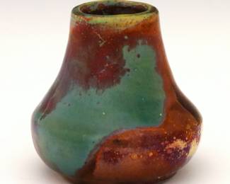 A miniature early 20th century Pewabic Art Pottery vase.  Baluster form with Iridescent glaze in mottled shades of Blue and Oxblood.  Impressed "Pewabic Detroit" mark.  Two small flakes at rim with painted touch-ups, some crazing.  2 1/4" high.