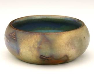 A miniature early 20th century Pewabic Art Pottery bowl.  Low form with Iridescent glaze in mottled shades of Green and Gold.  Impressed "Pewabic Detroit" mark.  Minor surface wear and crazing.  3 1/4" diameter x 1 1/2" high.