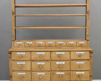 A late 19th century Apothecary cabinet.  Pine two part construction with open upper shelves and seven dovetailed drawers, base with twenty additional drawers all with enameled metal labels.  Older painted finish with wear and minor damage.  54 x 14 x 90" high.  