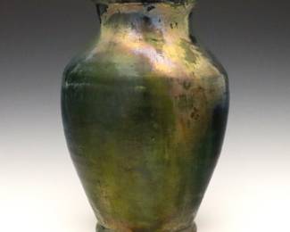 An early 20th century Pewabic Art Pottery vase.  Baluster form with flared rim and mottled lava glaze in shades of Iridescent Green, Blue and Gold.  Impressed "Pewabic Detroit" mark.  Minor wear, some crazing.  9 3/4" high. 