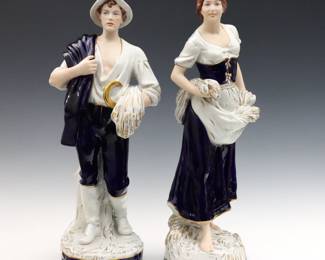 A pair of 20th century Royal Dux porcelain Harvest figures.  Allegorical depiction of Autumn, includes a man and woman standing with sheaths of wheat and sickle in multi-color glazes and Cobalt Blue clothing.  Applied Pink "Royal Dux" lozenge and impressed numerals "2445" and "1572".  Minor wear.  Each 21" high.  NOTE: From the estate of Bill & Barbara Shulhof of Saginaw, Michigan.