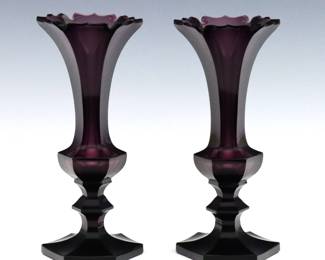 A pair of 19th century American Pressed Glass vases.  Hexagonal Amethyst glass bodies with cut scalloped rim and flared foot.  A few tiny flakes at rims, minor surface wear.  Each 7 1/4" high.    NOTE: From the estate of Bill & Barbara Shulhof of Saginaw, Michigan.