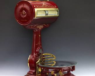 A late 19th/early 20th century model 155 Grocery store scale by the "Detroit Standard Computing Scale Co.".  Professionally restored counter top scale in burgundy paint with stenciled detail and Brass accents including a cast marquee, features a two sided readout cylinder with windows on front and rear, on a shaped column and base with glass product plate.  Very good condition with minor wear in working condition.  33" high.  ESTIMATE $600-800 