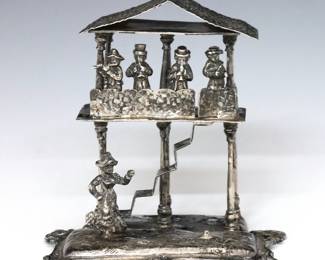 A turn of the century English Sterling Silver miniature figural grouping by John George Piddington.  Depicts musicians playing instruments at the upper level of a stilt house while a lone woman dances below.  London hallmarks with "JPD" maker's mark, a second mark with "C" below a Crown, and "F" date letter indicating a production date of 1901.  4.93 troy ozs total.  Minor surface wear.  3 1/2" high.  NOTE: From the estate of Bill & Barbara Shulhof of Saginaw, Michigan.
