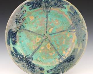 An early 20th century Pewabic Pottery plate.  Circular form decorated with Blue Arts & Crafts style Dragonflies with Iridescent glaze in shades of Green and Blue.  Unmarked.  Wear, crazing, painted touch-ups in areas of flaking.  10" diameter. 