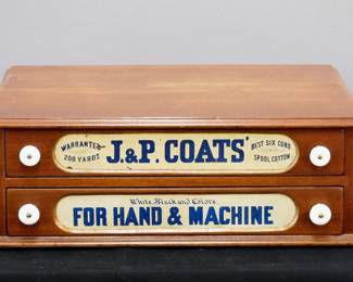 A turn of the century J. P. Coats counter top thread cabinet.  Walnut construction features two drawers with painted labels and porcelain knobs.  Refinished with minor wear.  19 x 15 1/2 x 7" high.  