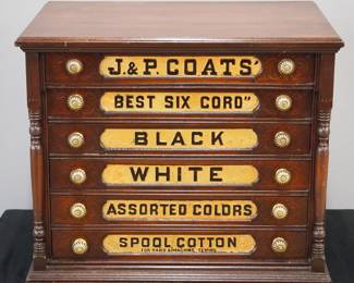 A turn of the century J. P. Coats counter top thread cabinet.  Cherry construction features six labeled drawers and Brass knobs flanked by turned columns and advertising panel verso.  Old finish with wear and touchups, labels strengthened.  26 x 19 1/4 x 22 1/4" high. 