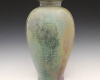 An early 20th century Pewabic Art Pottery vase.  Baluster form with flared rim, ribbed linear texture and Iridescent glaze in shades of Pale Green, Blue and Pink.  Retains original "Pewabic Detroit" medallion paper label, attributed to Mary Chase Stratton at label on underside.  Minor surface wear.  12 1/2" high.