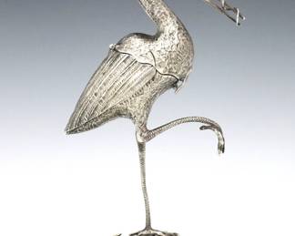 A turn of the century Dutch Sterling Stork spice box.  Figural Stork form box with Red gemstone eyes, posed standing with one leg raised and a serpent in its beak.  Hinged body opens to reveal a compartment to store spices.  Dutch Lion Rampant and Minerva Head hallmarks, "R" and partial maker's mark.  2.99 troy ozs total.  Some surface wear, inscribed and dated "1902" and base.  6 1/2" high.   NOTE: From the estate of Bill & Barbara Shulhof of Saginaw, Michigan.