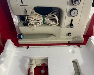 Bernini older sewing machine in red plastic case 