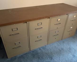 There are a lot of file cabinets 
These is a set of 4 with a heavy wood top
