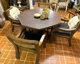 Solid wood game table and chairs on casters. Leather seats with large nail heads. Excellent Condition