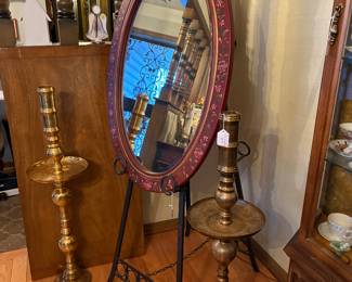 Floor Brass etched candle stands from India.  Floor easel is iron.  Beveled oval mirror.