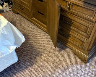 Thomasville triple dresser with 3 drawers behind door and mirror.