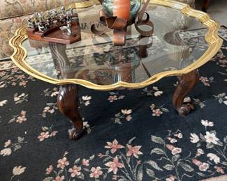 Scalloped glass top Hollywood Regency Table with gold trim. Wood Base. 40"
