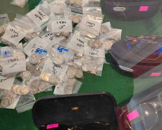 Silver dimes, quarters, half dollars and sunglasses 