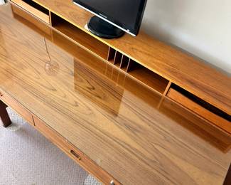 ALTERNATE VIEW: Lovig Mid Century Teak Desk. In good condition with normal wear. Top has been protected with fitted glass. Measurements: 64"W x 28 1/2"D x 29"H. AVAILABLE FOR: $2100
