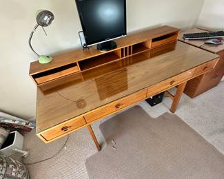 ALTERNATE VIEW: Lovig Mid Century Teak Desk. In good condition with normal wear. Top has been protected with fitted glass. Measurements: 64"W x 28 1/2"D x 29"H. AVAILABLE FOR: $2100