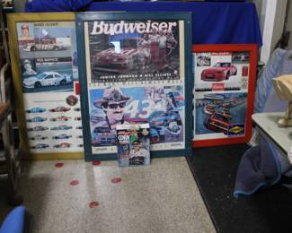 Large posters featuring Budweiser and racing posters.
