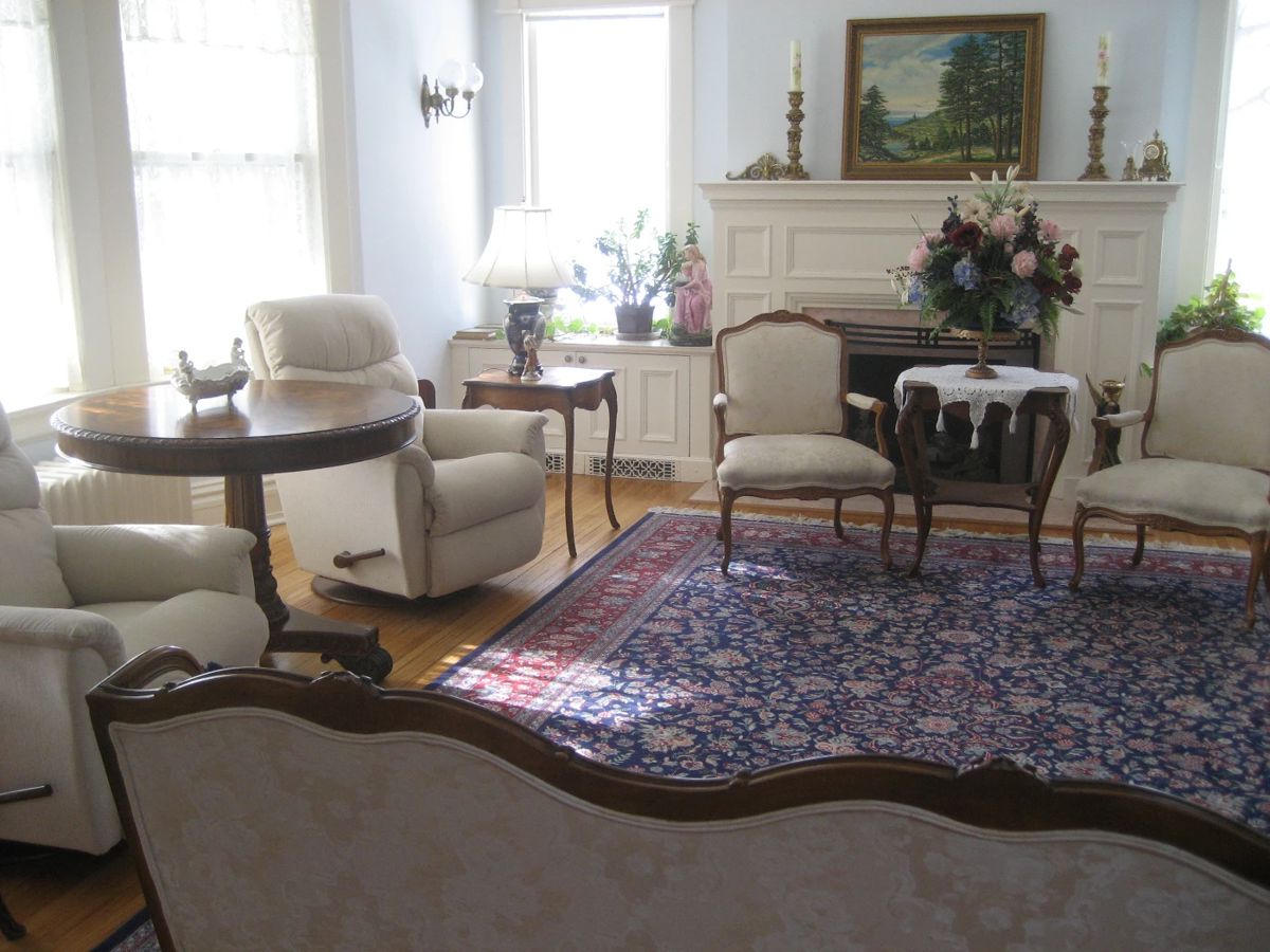 Exquisite furnishings including French style chairs (pair), Sino-Tabriz 9'9" x 13'9" wool and silk Oriental rug, antique occasional tables, luxury recliners (pair)