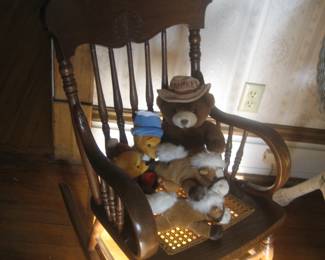 Child's rocking chair with cane seat, stuffed animals