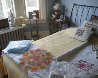 Wrought iron headboard, accent pillows, hurricane lamp, linens