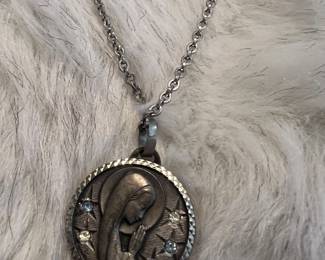large religious pendant necklace featuring the Virgin Mary