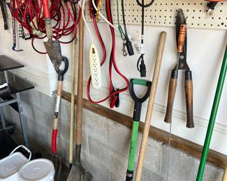 Assorted gardening tools and power cables