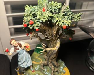 The Wizard of Oz Dorothy figurine picking from Apple tree
