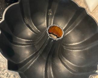 black, nonstick Bundt cake pan with a fluted design