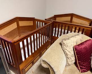 Pair of wooden baby beds with mattresses
