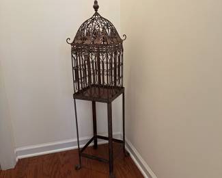 H40 - $35. Decorative Metal Bird Cage on Stand. Measures 46" tall. 