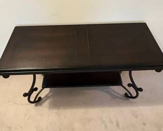 H75 - $60. Sofa Table. Wooden top with metal base. Measures 48" x 20" x 28.75" tall. 