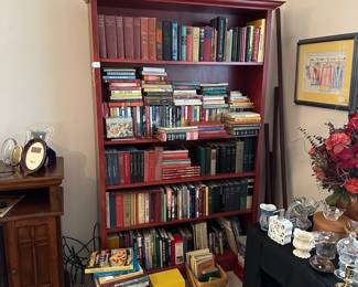 H41 - $100. Red Bookcase - shelves are NOT adjustable. Measures 52" at the widest trim. Main frame is 47" x 11.5" deep x 77" tall. Very good condition!