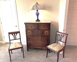 Tiffany style lamp with lighted base                                  Duncan Phyfe inspired-empire style mahogany lyre-back chair with patterned upholstered seat.    Berkey and Kay Style Dresser 38" x 47" x 19"
