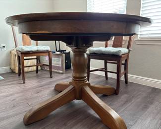 Solid Wood Distressed Pedestal dining table with 6 chairs  31” H x 45” D
27” at tall at apron
Has one leaf to that extend stable to 52" and two armchairs