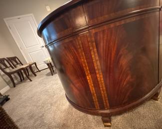 Maitland-Smith Regency Style inlayed Mahogany oval  desk with pristine hand tooled leather writing surface.                                                                                                          28" H 63 1/2" W X 26" D          