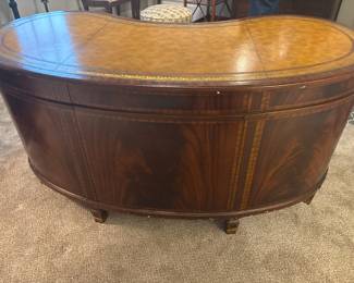 Maitland-Smith Regency Style inlayed Mahogony oval partners desk with pristine hand tooled leather writing surface.                                                                                                          28" H 63 1/2" W X 26" D          